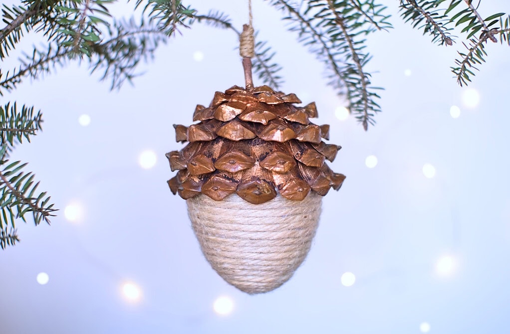 adorno navideño colgante con forma de bellota hecho con cuerda y escamas de piña