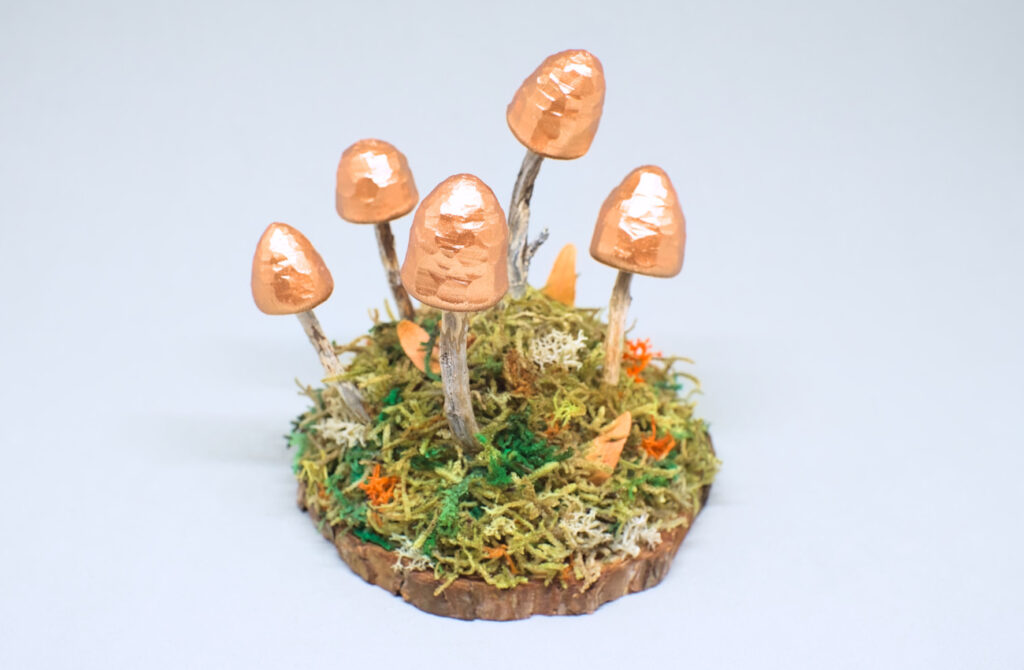 pequeño adorno de otoño hecho con setas talladas en madera