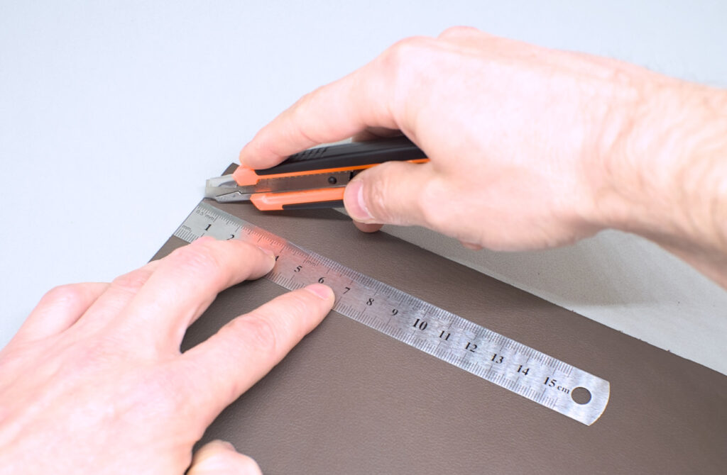 cortando tira de cuero marron