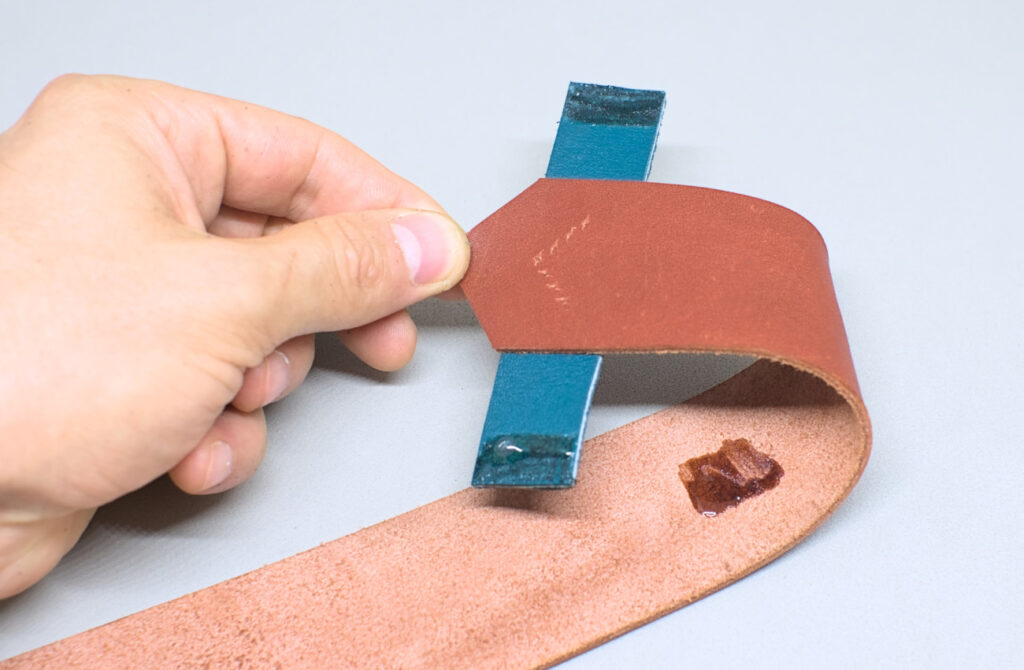 adhiriendo extremo puntiagudo con tira de cuero para dar forma a funda de abanico